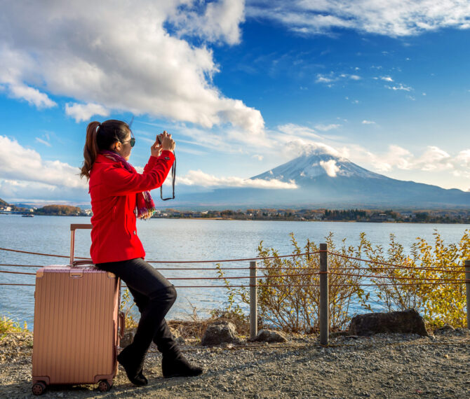 Woman take a photo at Fuji mountains. Autumn in Japan. Travel concept.